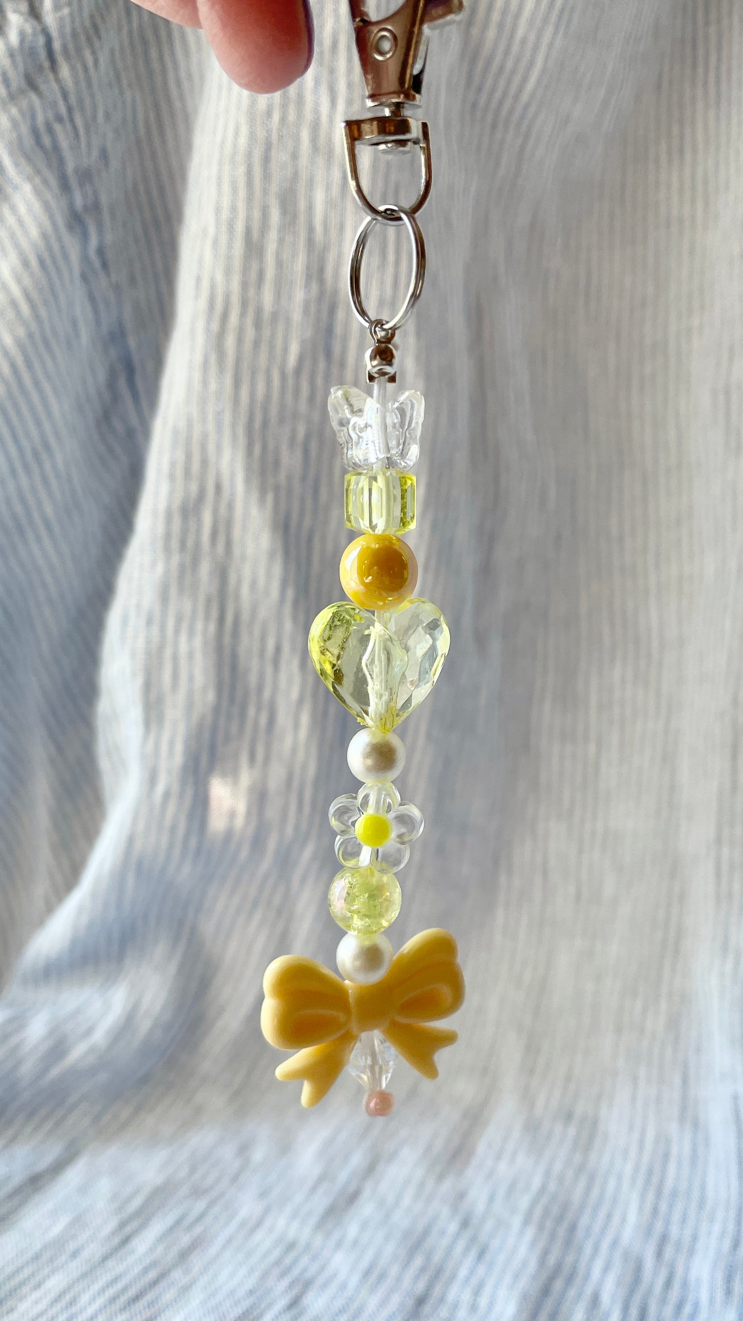 Yellow beaded Bag Charm with heart, flower and bow charms
