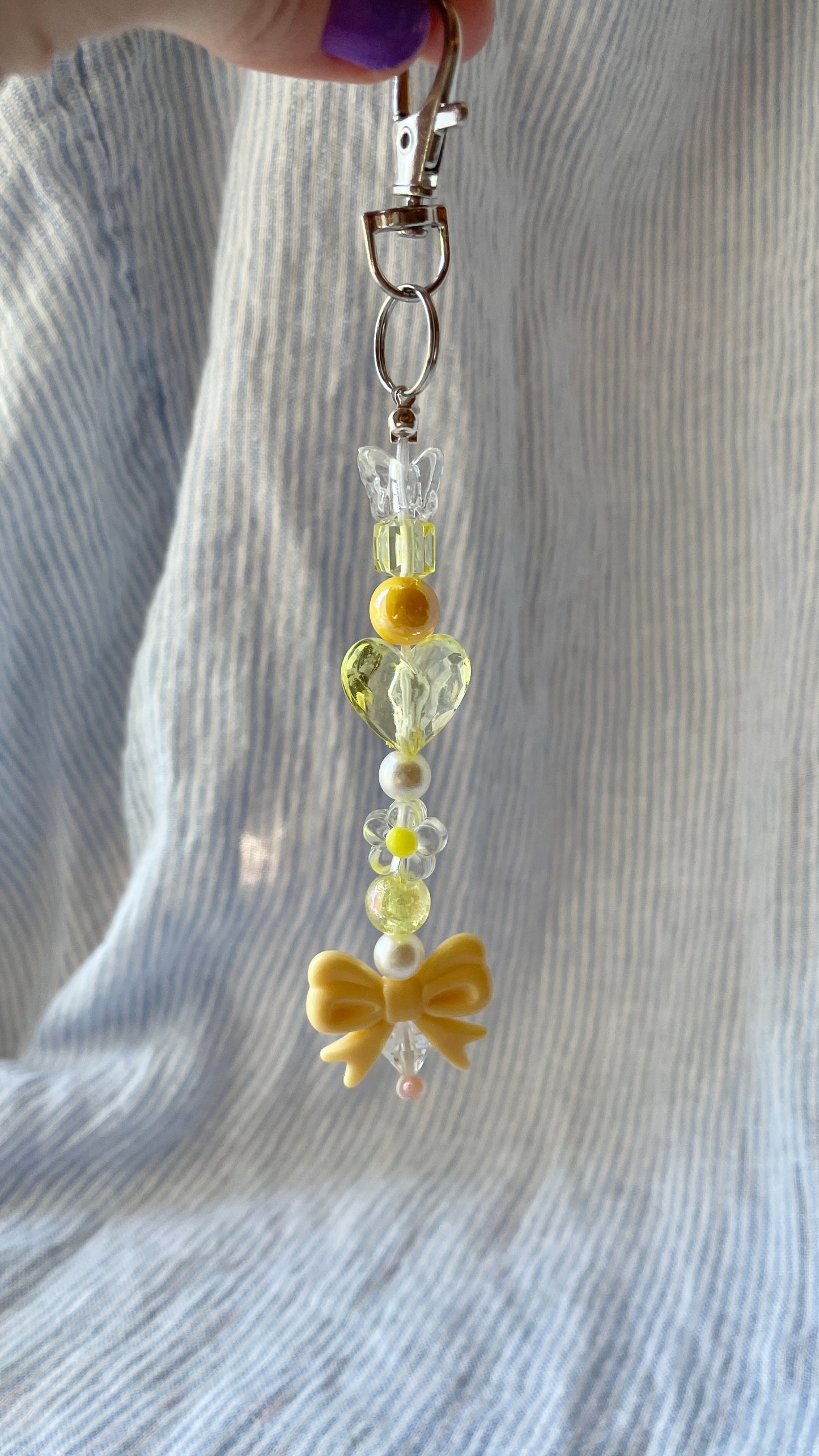 Yellow beaded Bag Charm with heart, flower and bow charms