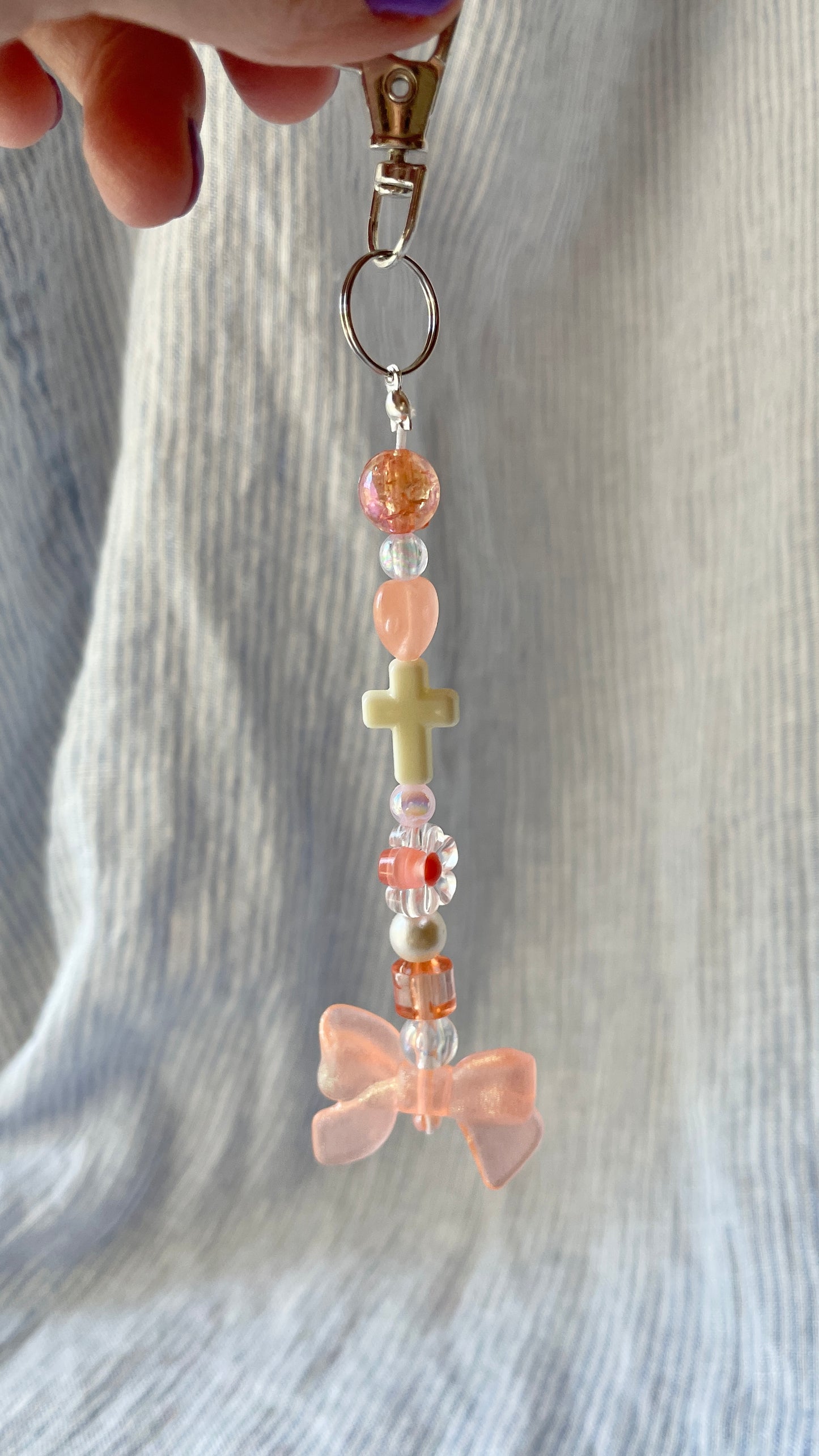 Peachy orange bow and cross beaded Bag Charm