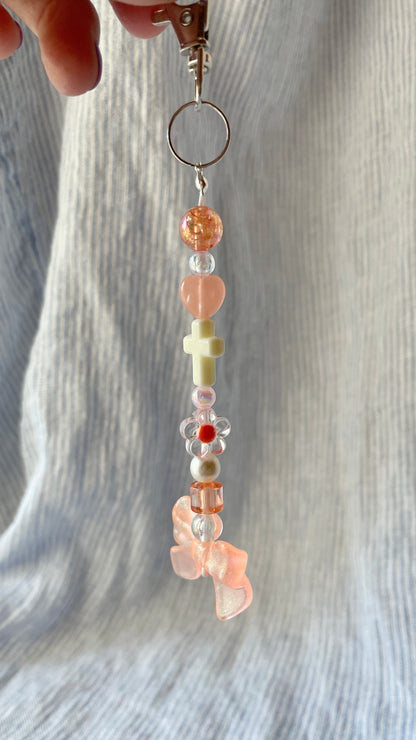 Peachy orange bow and cross beaded Bag Charm