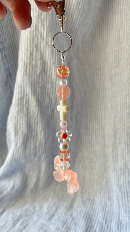 Peachy orange bow and cross beaded Bag Charm